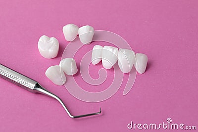 Dental tool and Zircon dentures on a pink background - Ceramic veneers - lumineers Stock Photo
