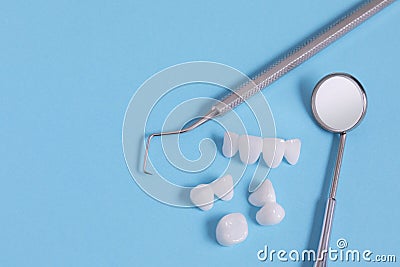 Zircon dentures Surrounded by dental instruments - Ceramic veneers - lumineers Stock Photo