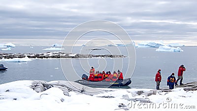 Zodiac approaching snow covered slopes in Antarctica Editorial Stock Photo