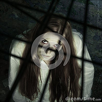 Zombie girl behind lattice Stock Photo