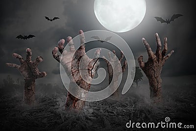 Zombie hand rising out of the ground Stock Photo