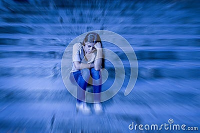 Zoom blur edited portrait of young sad and depressed woman or teen girl sitting lonely at street staircase looking desperate and s Stock Photo