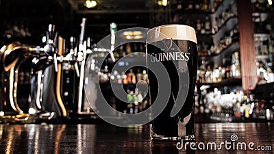 Zoom in on a glass of Guinness beer in a bar Editorial Stock Photo