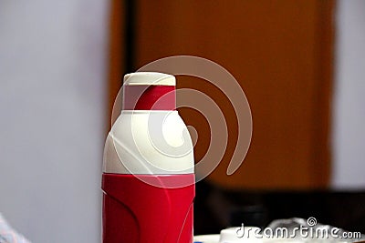Zoom photograph of a red and off white colored bottle Stock Photo