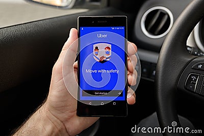 ZRENJANIN, SERBIA - APRIL 2, 2021: Male hand holding smartphone with Uber app screen in the car Editorial Stock Photo