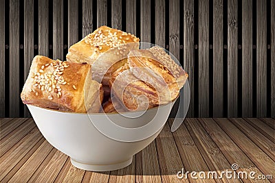 Bowl Of Freshly Baked Zuzu Square Sesame Puff Croissant Pastry Set On Rustic Bamboo Place Mat Stock Photo