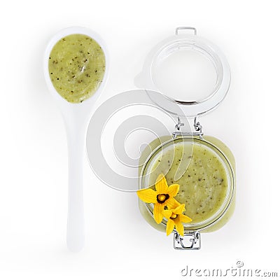 Zucchini green sauce in jar with flowers and spoon food top view Stock Photo
