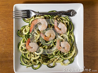zucchini noodles with pesto and sauteed onions Stock Photo