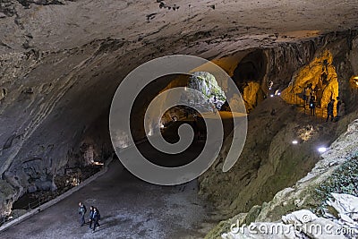 ZugarA group of tourists visit the interior of the Cave of the Witches of Zugarramurdi Editorial Stock Photo