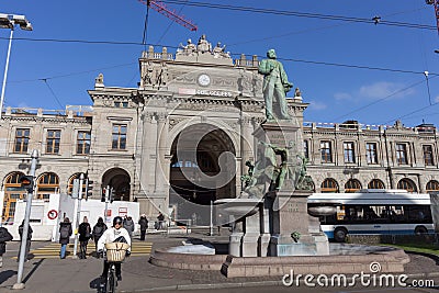 People, cars and monument to Alfred Escher on Bahnhofplatz square Editorial Stock Photo