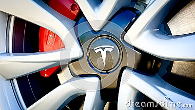 Zurich, Switzerland - May, 2020, Close-up of famous car manufacturer Tesla logo on grey wheel rim with red brakes Editorial Stock Photo