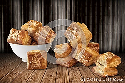 Bunch Of Zuzu Square Sesame Puff Croissant Pastry Set On Rustic Bamboo Place Mat Stock Photo