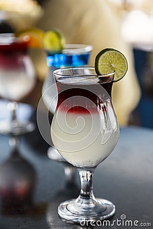 Appertizing colourful Cocktails with lime on a bar Stock Photo
