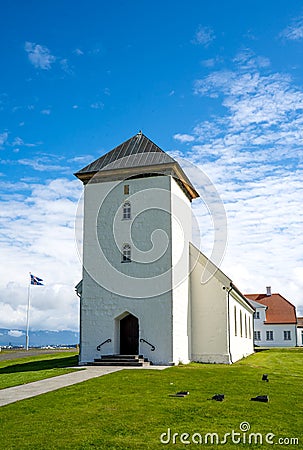Vertical view of the church of the Bessastadir, a modest group of white, red-roofed buildings Editorial Stock Photo