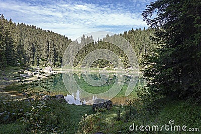 ï»¿ï»¿reflections on Lake Carezza karersee, Nova Levante, South Tyrol. Stock Photo