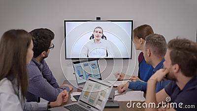 Команда разработчиков мобильных приложений общается по видеозвонку со специалистом в конференц-зале в офисе сток-видео Команда разработчиков мобильных приложений общается по видеозвонку со специалистом в конференц-зале в офисе сток-видео