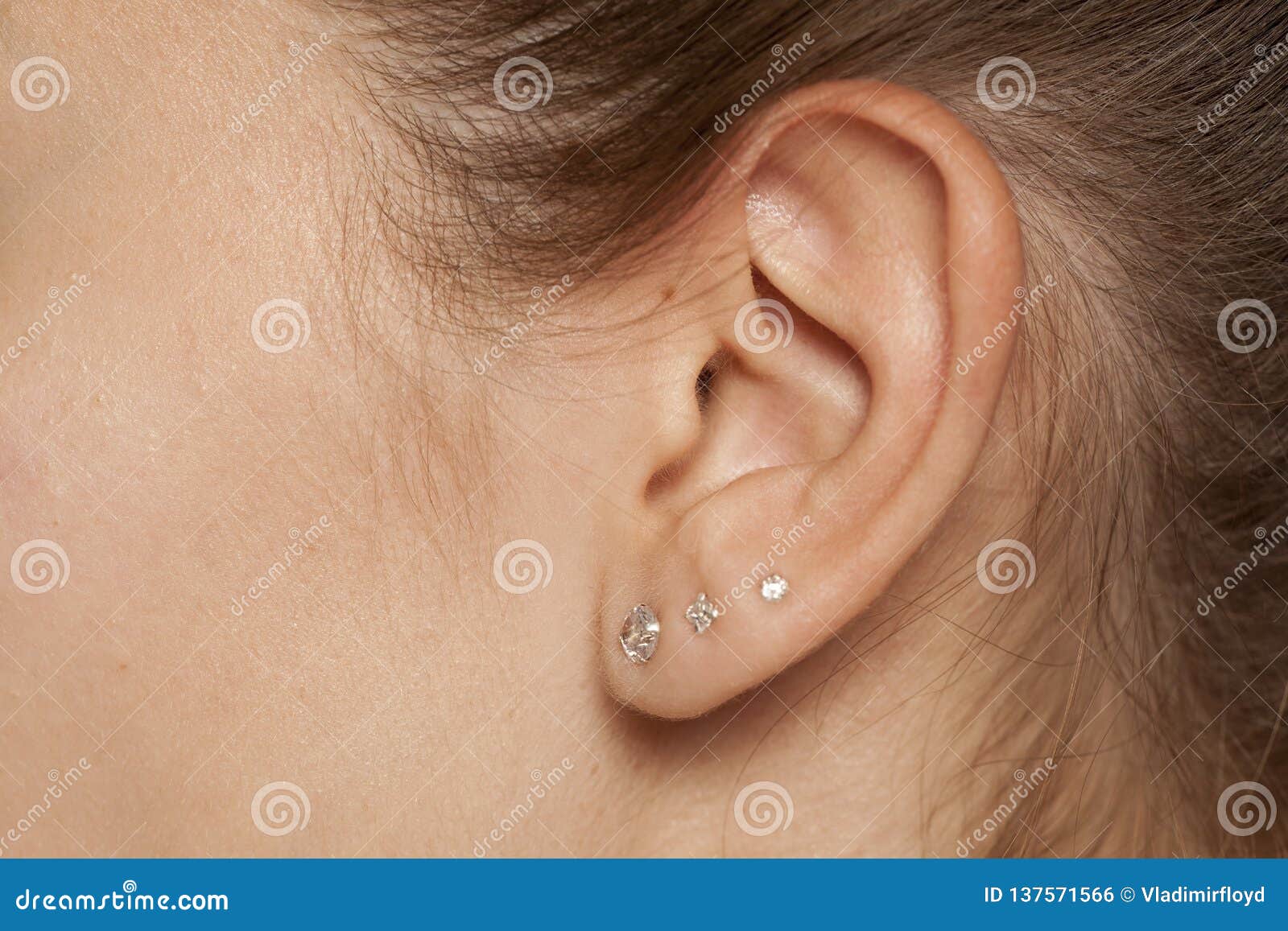 Θηλυκό αυτί με τα σκουλαρίκια Στοκ Εικόνες - εικόνα από : 137571566