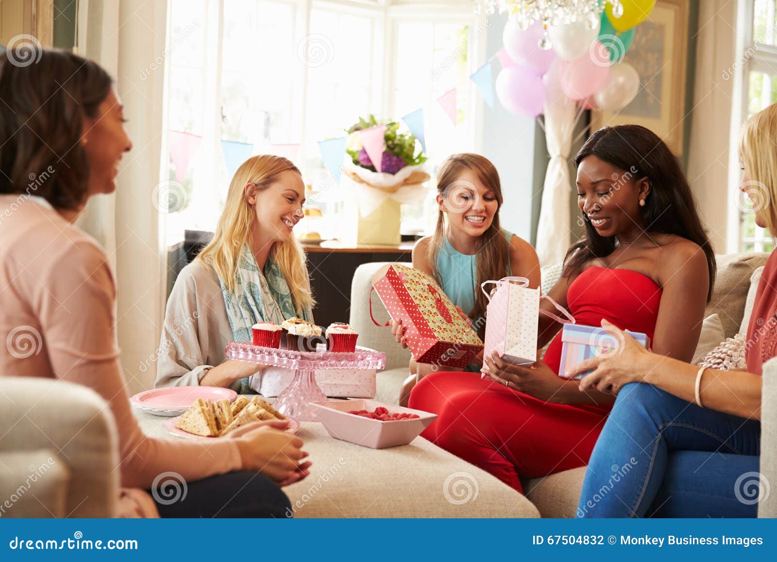 New mom friends. Party mother. Friends the one with the Baby Shower. Cheerleaders receiving Gifts. Embracing friend meeting.