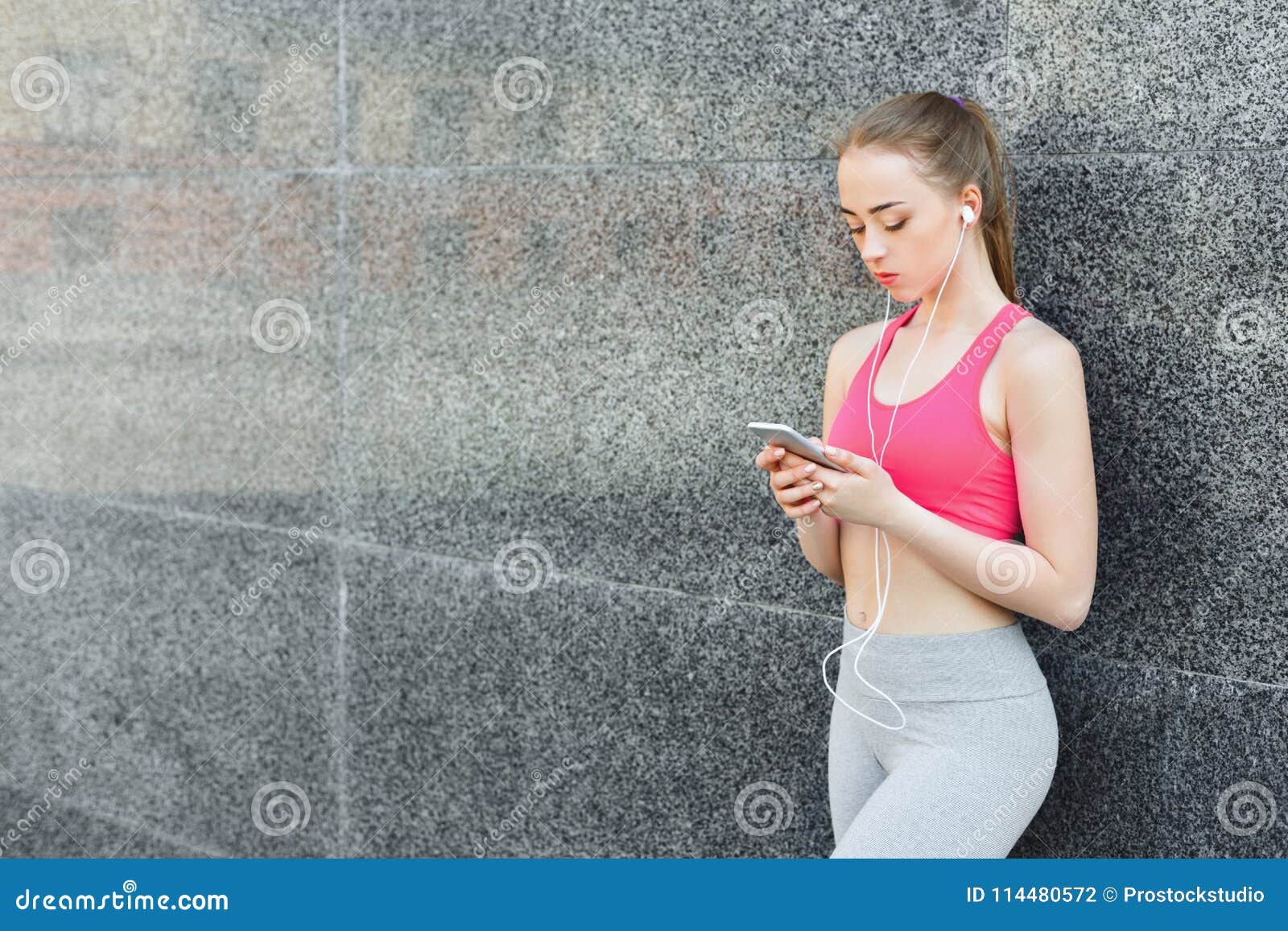 Женщина Выбирает Музыку Для Того Чтобы Слушать Во Время Jogging.
