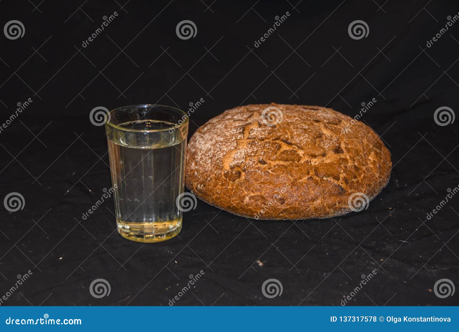 Круглый хлебец черного хлеба и граненного стекла воды на черной бедности  абстракции предпосылки Стоковое Фото - изображение насчитывающей свеже,  вода: 137317578