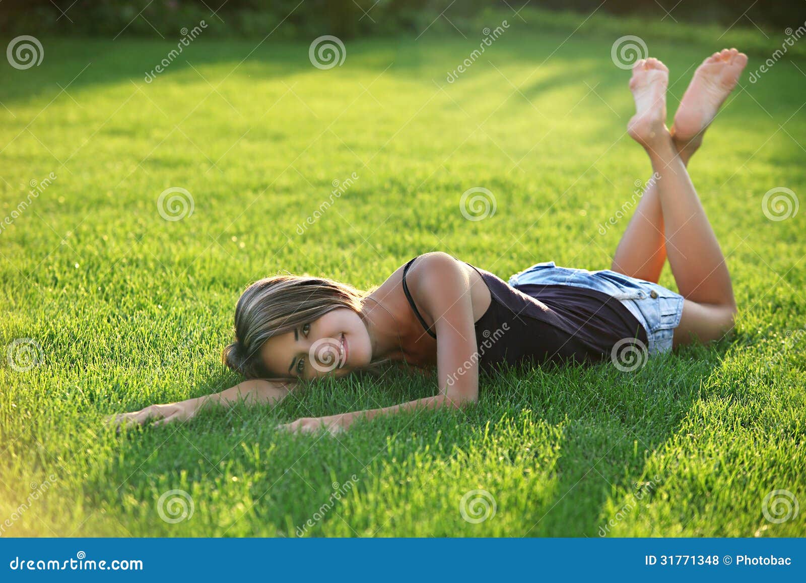 Спать с поднятыми ногами. Девушка лежит на траве. Девушка лежит на лужайке. Девушки лежат на траве босиком. Подросток лежит на траве.