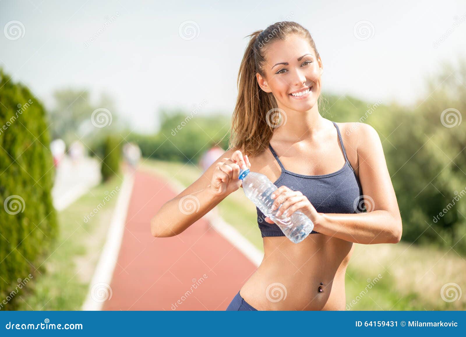 Вода после бега. Спортивная девушка с бутылкой воды. Спортивная женщина держит в руках. Фотография освежения. Фотографии молодых девушек которые ведут активный образ жизни.