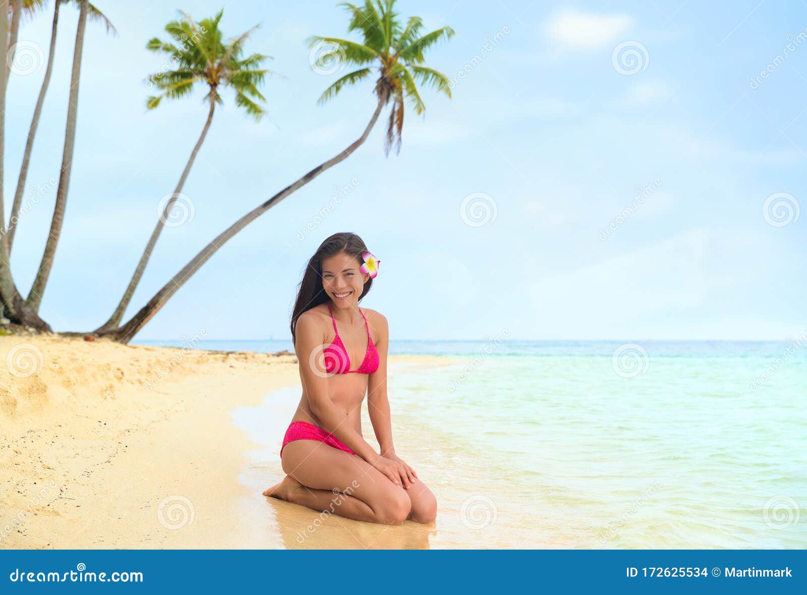 大溪地豪华旅游度假岛美丽的比基尼模特，身着红色泳装，在沙滩上放松  image
