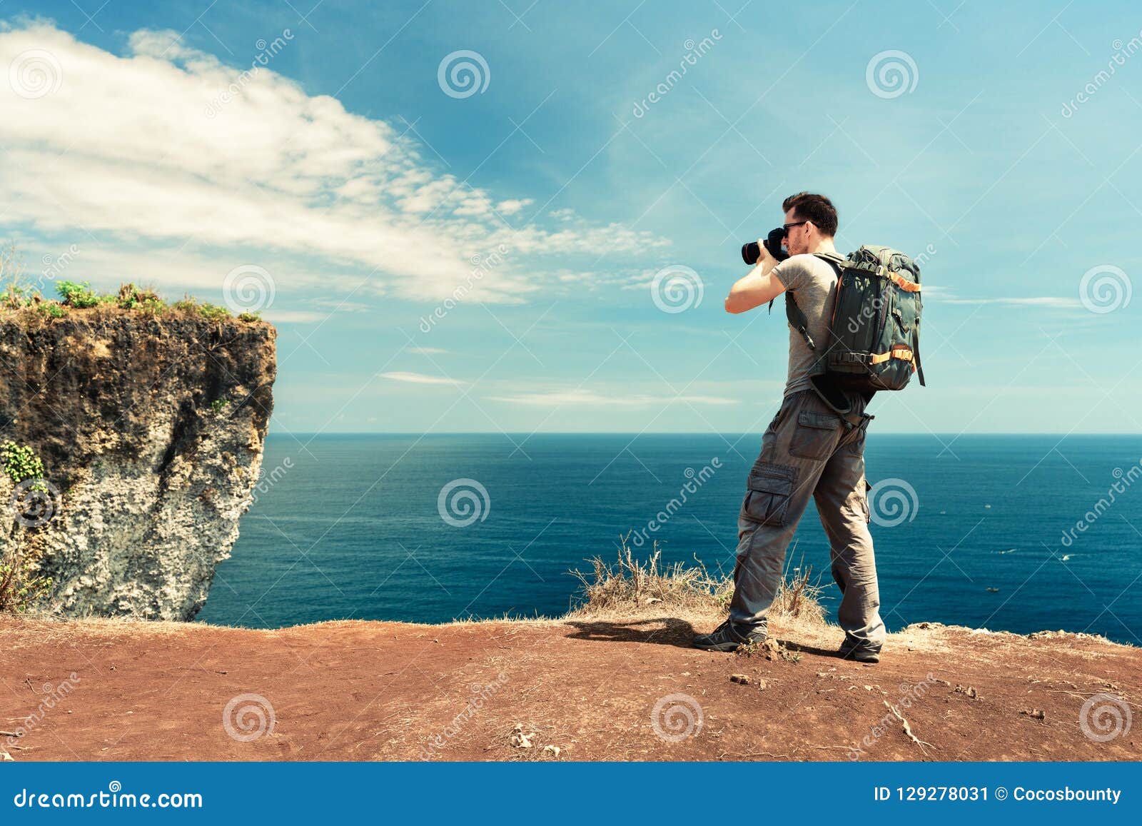 旅客有照相机的人背包徒步旅行者在自然背景在手中做照片热带海滩库存图片 图片包括有旅客有照相机的人背包徒步旅行者在自然背景在手中做照片热带海滩