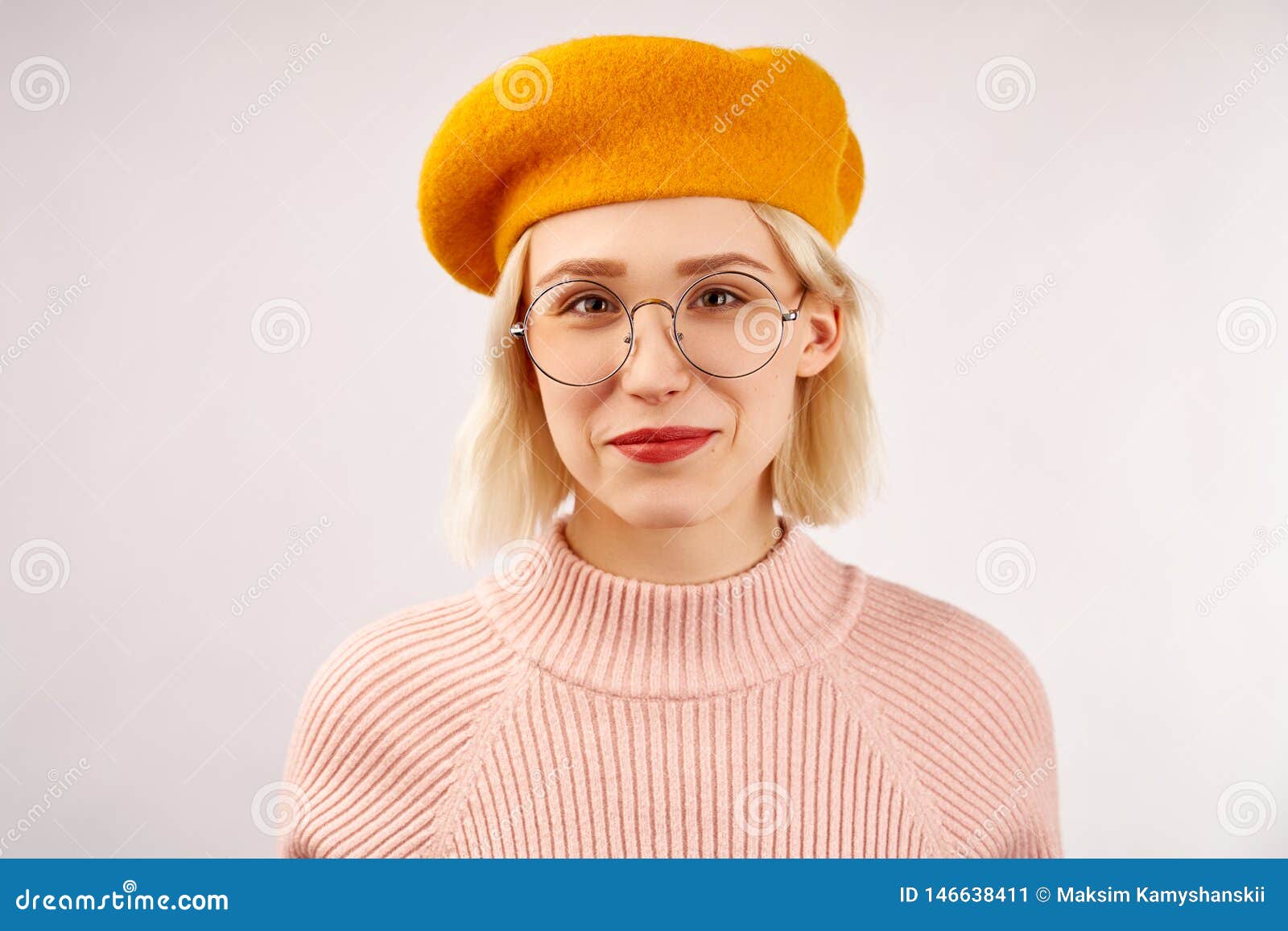 有引人注目的外观的 宽微笑快乐的少女 穿戴在黄色贝雷帽 温暖的桃红色被编织的毛线衣库存图片 图片包括有多彩多姿