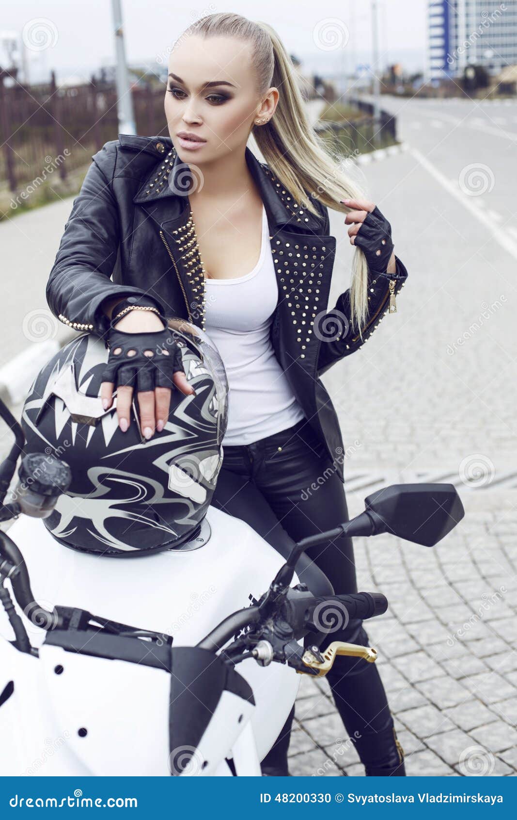 Girl With Long Blond Hair In Leather Jacket,posing On 