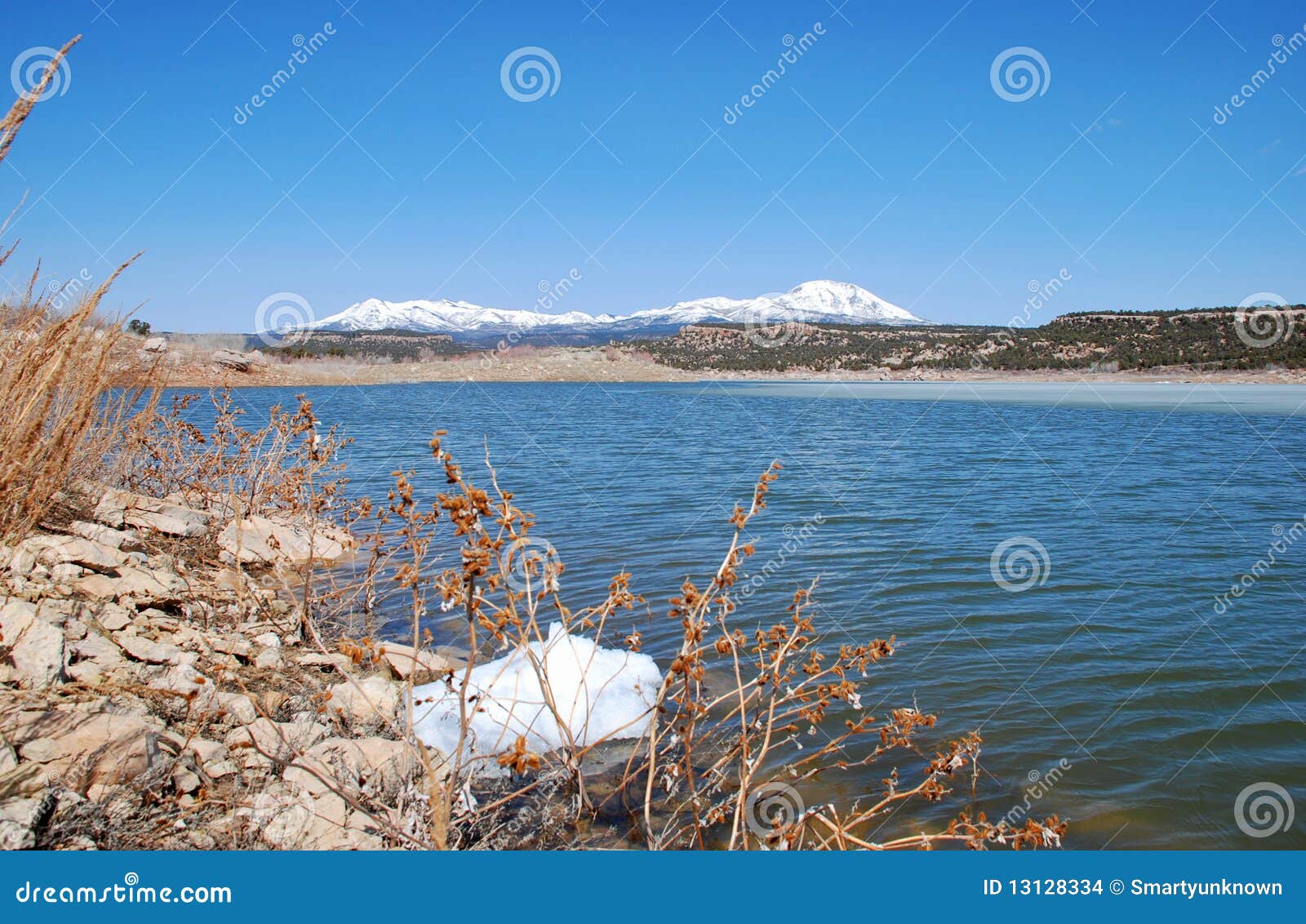 abajo mountains and winter lake in utah