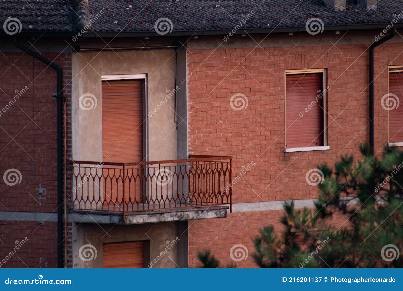 abandoned apartment with brick facades and closed windows, italy