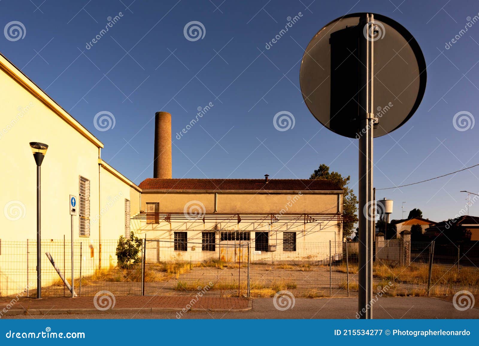 abandoned factory facade whit closed windows, italy