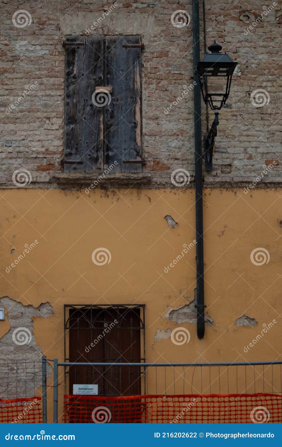 abandoned house with brick facades and closed windows, italy