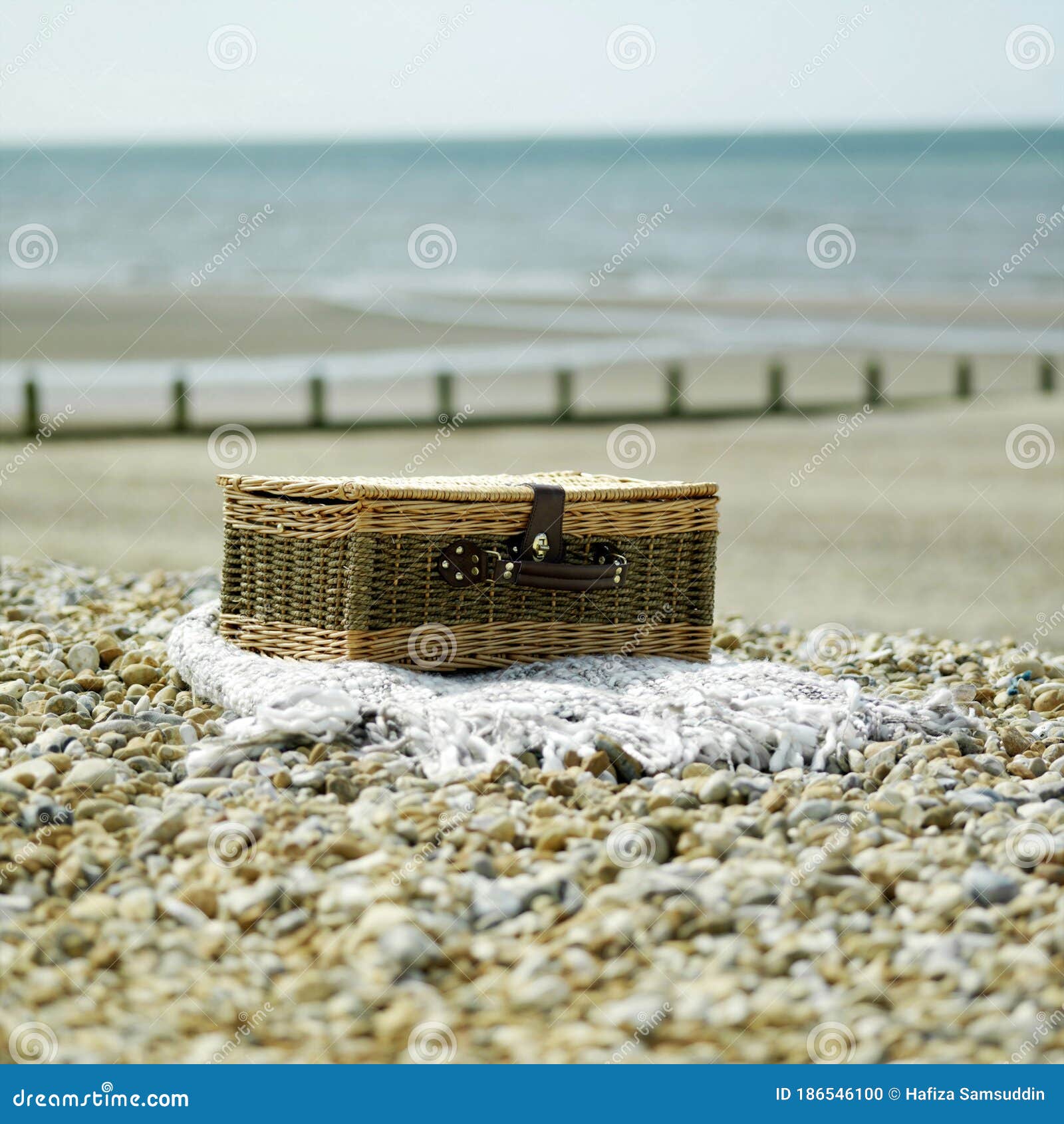 Abandoned Picnic Basket on the Beach. Conceptual Image Stock Photo