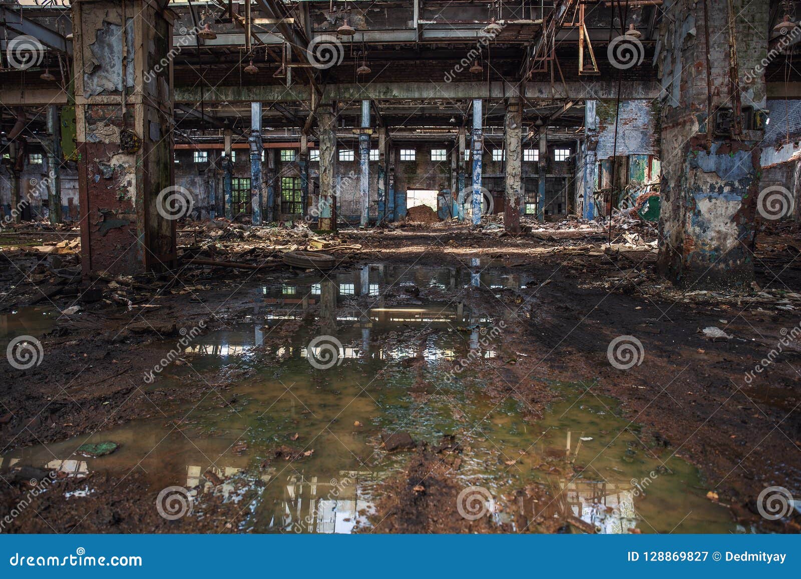 abandoned ruined industrial warehouse or factory building inside, corridor view with perspective, ruins and demolition concept