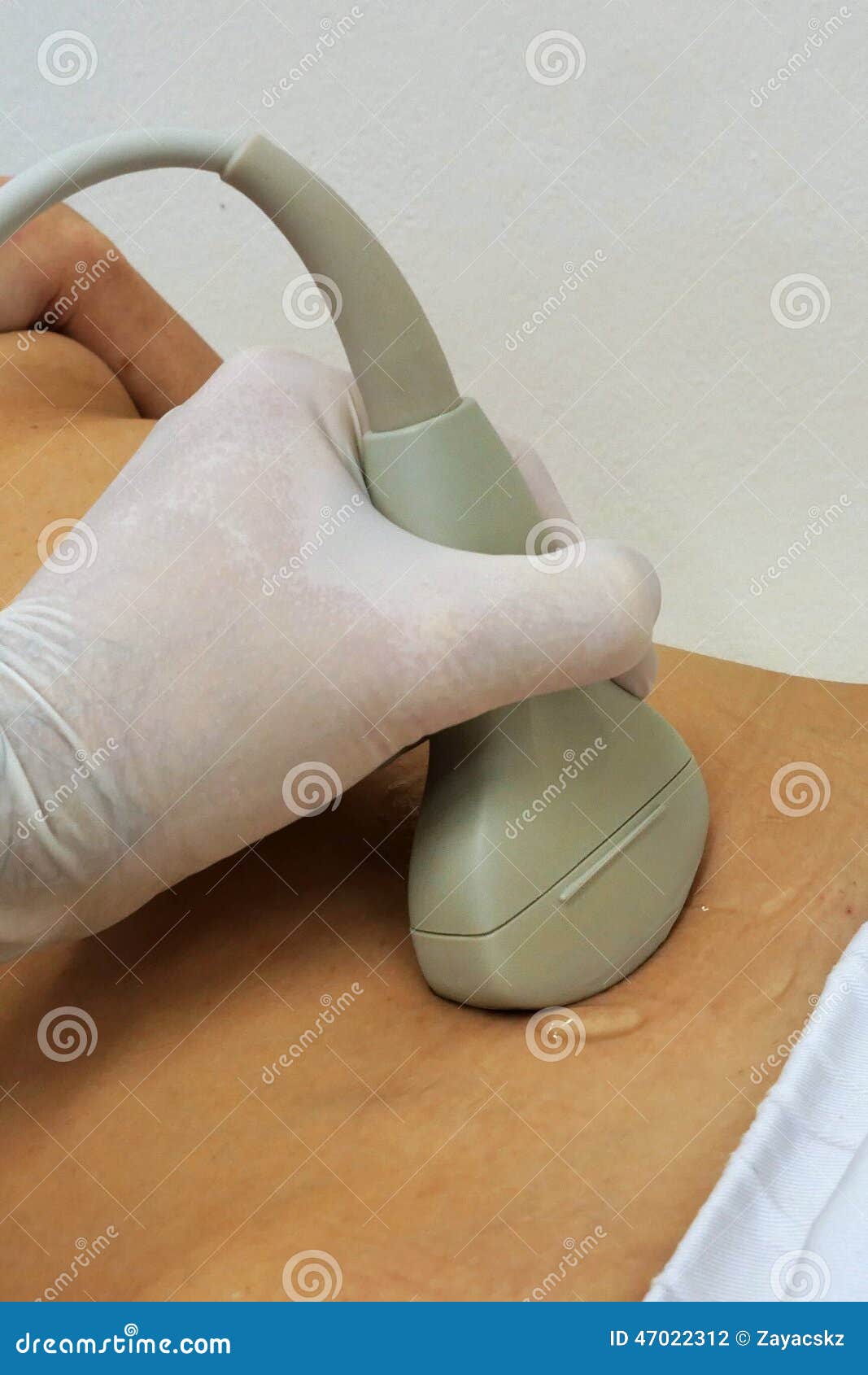 abdominal ultrasound convex probe held in left hand scanning female stomach