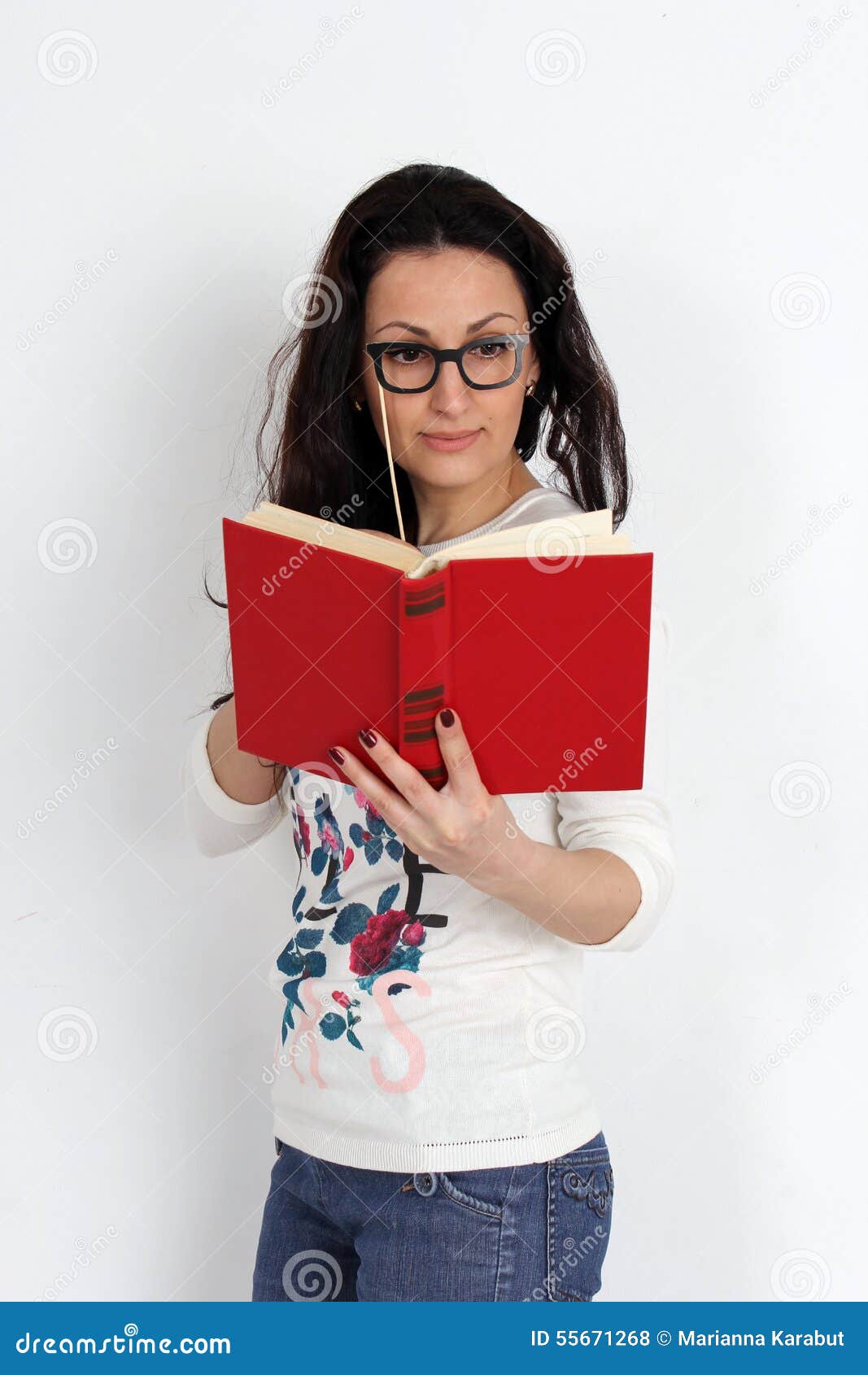 ABeautiful Young Woman Standing With Red Book In Hand. Studio Stock