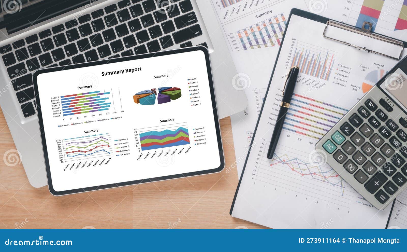 ablet with charts and reports on office desk workplace.
