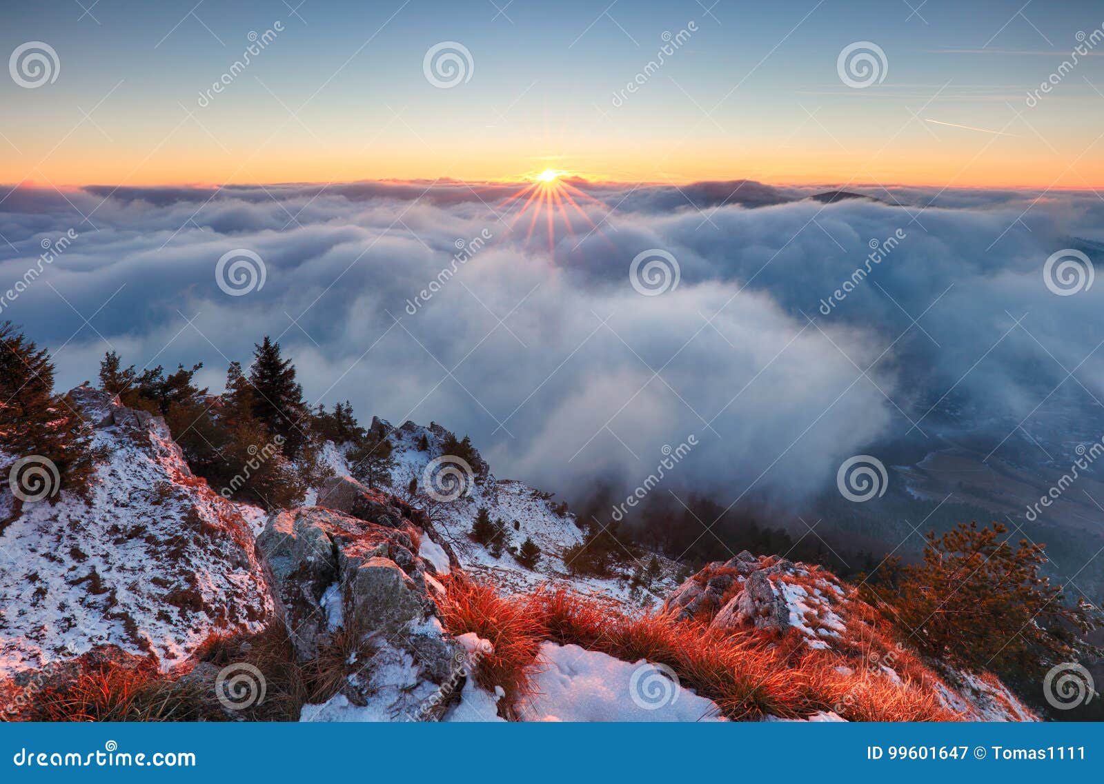above clouds in winter - mountain landcape at sunset, slovakia