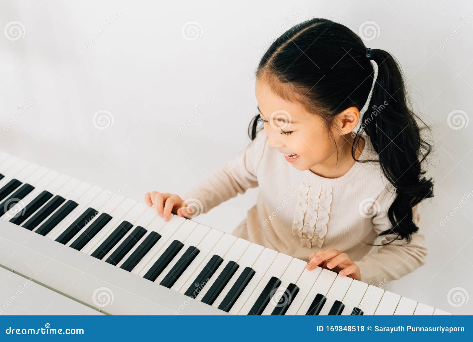 Satisfied Asian Kid Playing Piano at Home Stock Photo - Image of