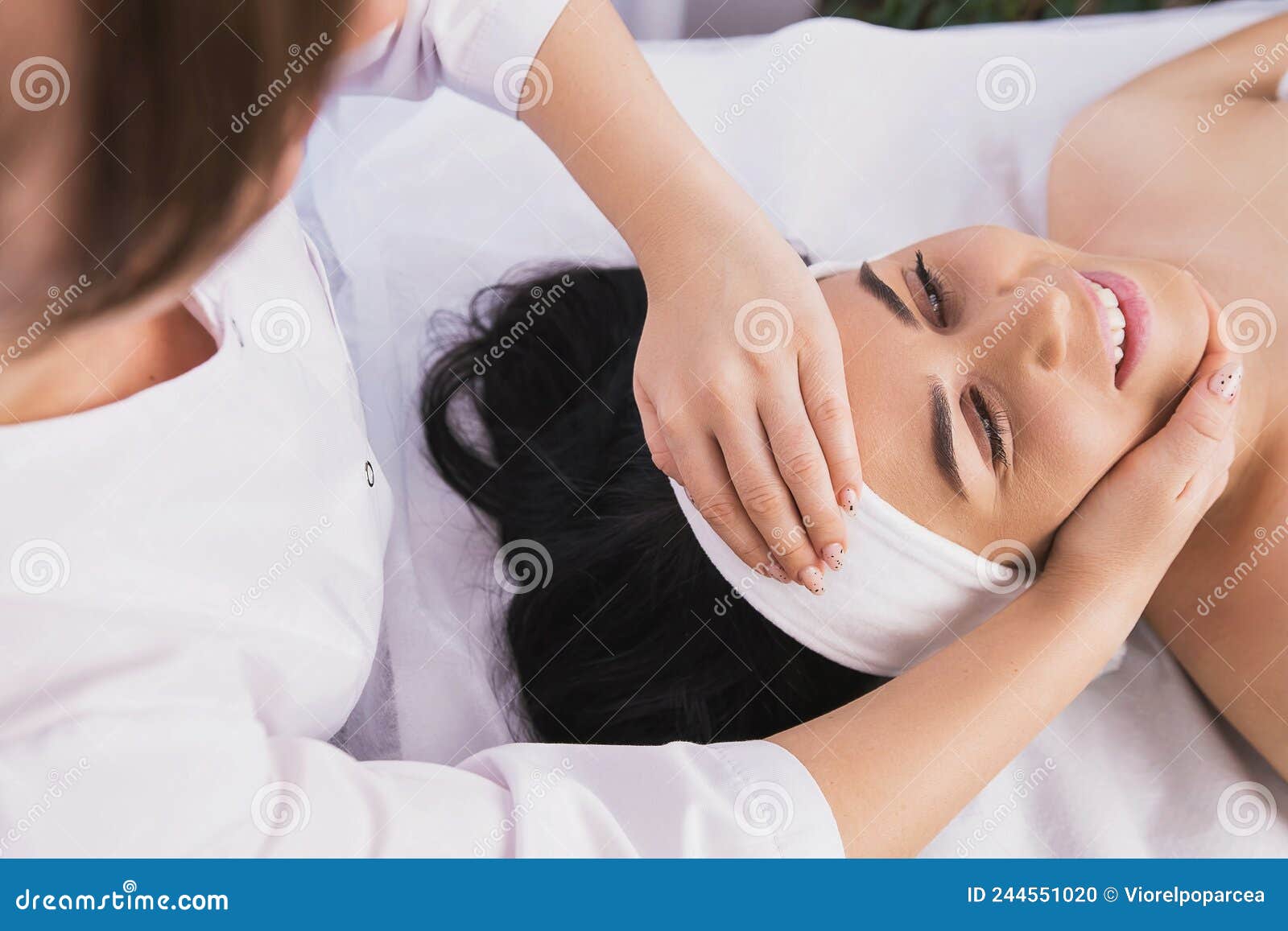 Above Photo Of Cosmetologist Making Facial Beauty Massage Treatment For Relaxed Young Woman Face