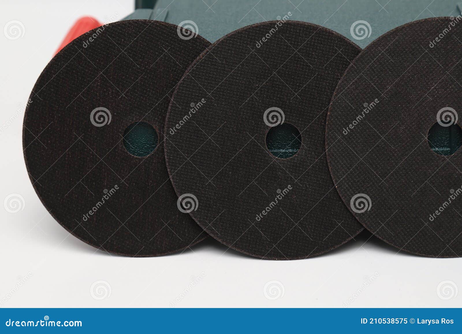 Abrasive Black Wheel, Grinding Wheel on the Background of the Green