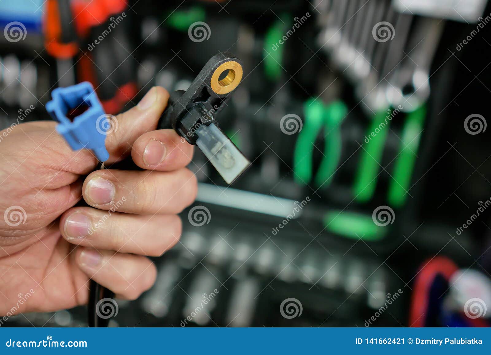 abs sensor in the hands of an auto mechanic.