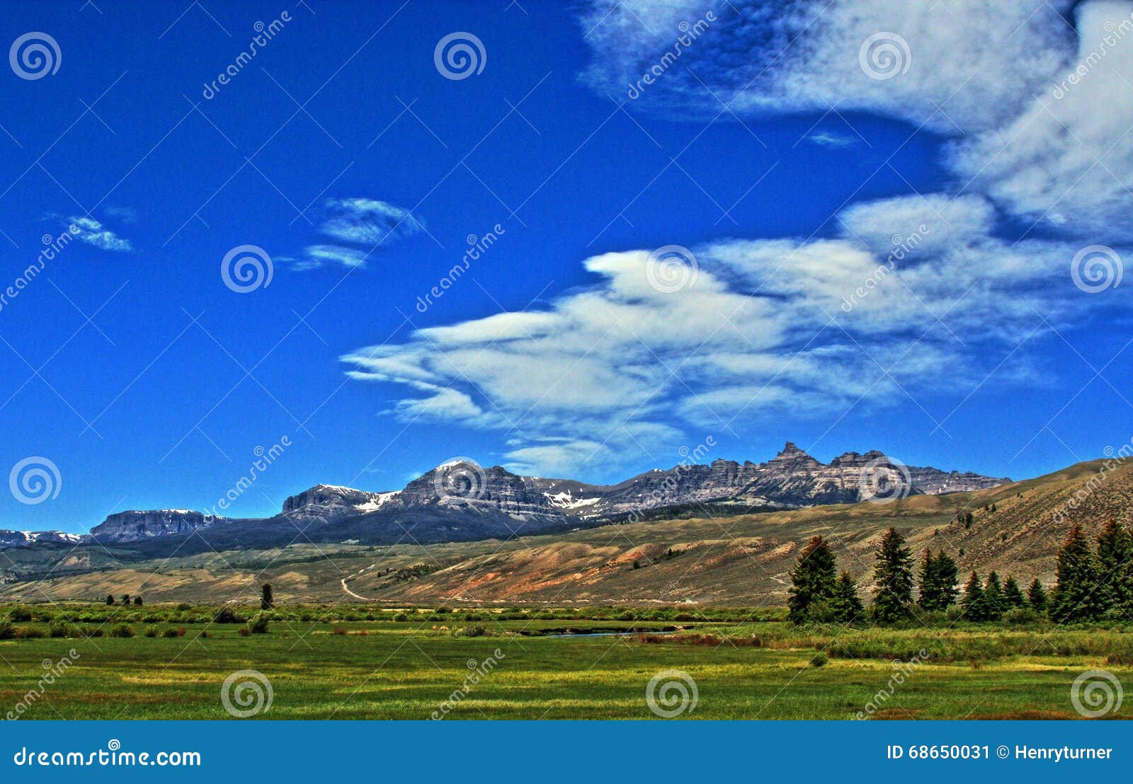 absaroka mountain range under summer cirrus and lenticular clouds near dubois wyoming