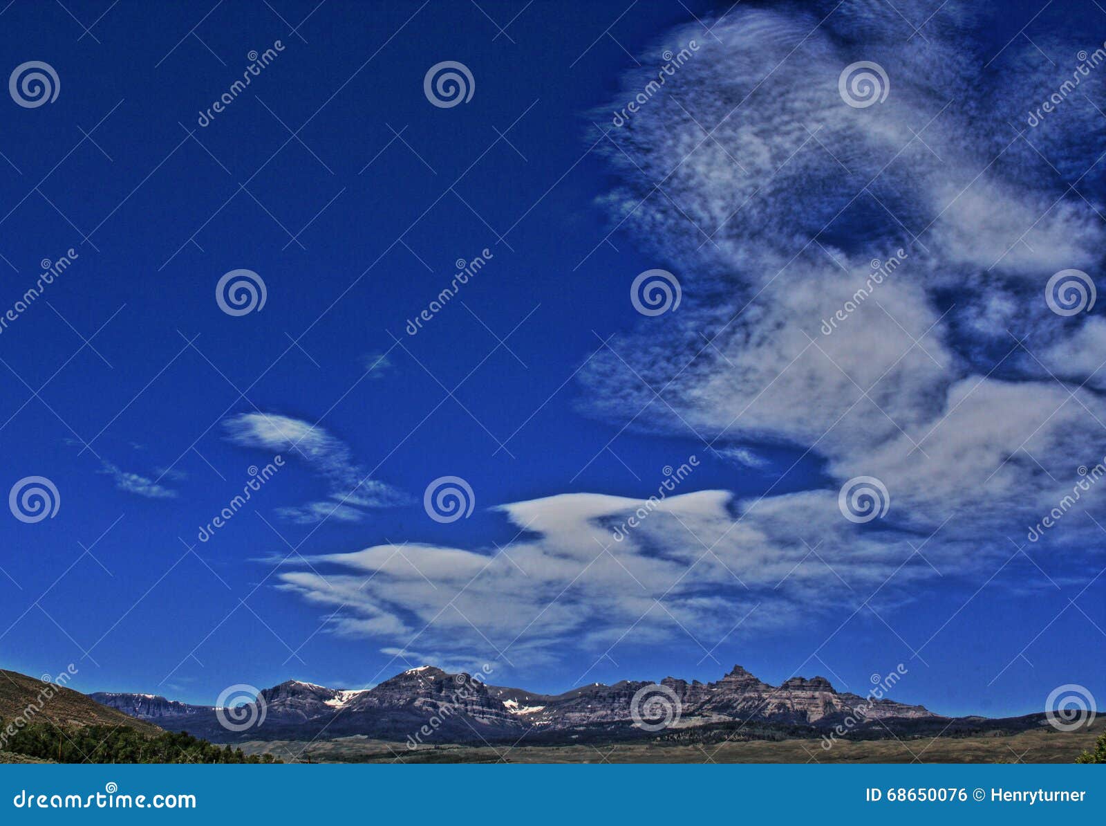 absaroka mountain range under summer cirrus and lenticular clouds near dubois wyoming