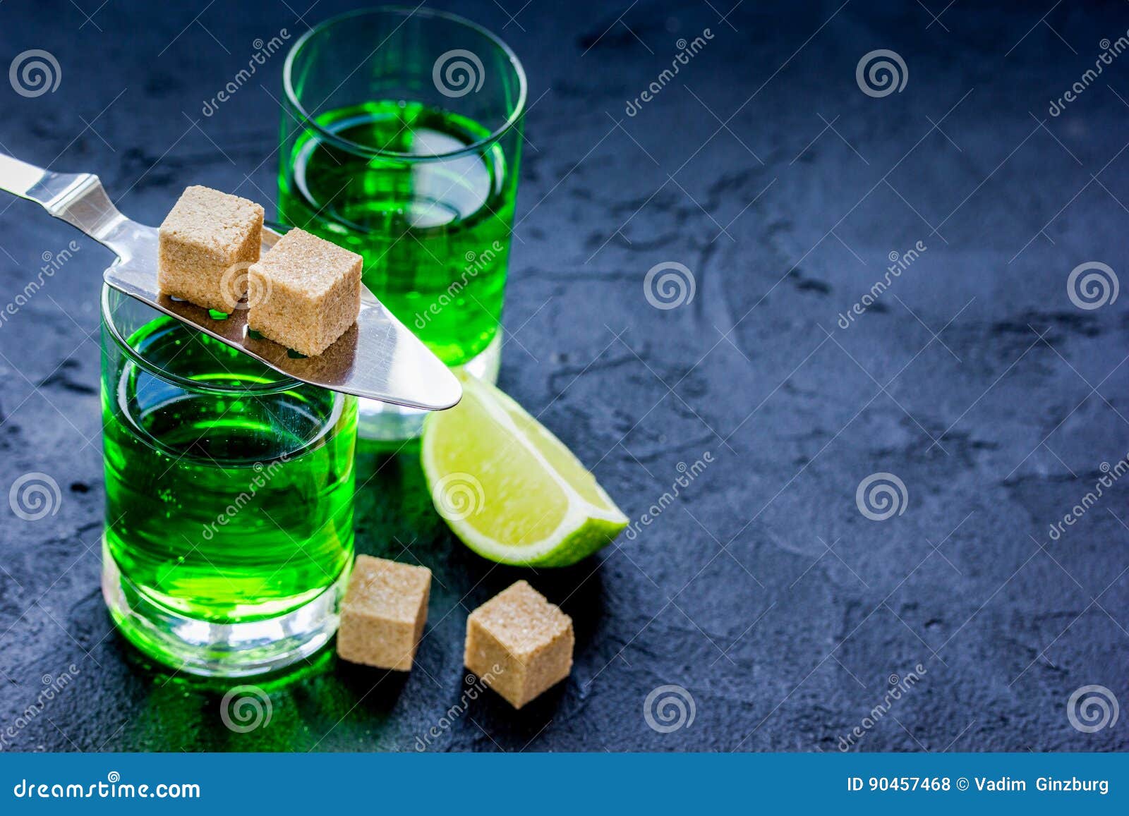 Absinthe with Sugar Cubes in Spoon on Dark Background Mock Up Stock