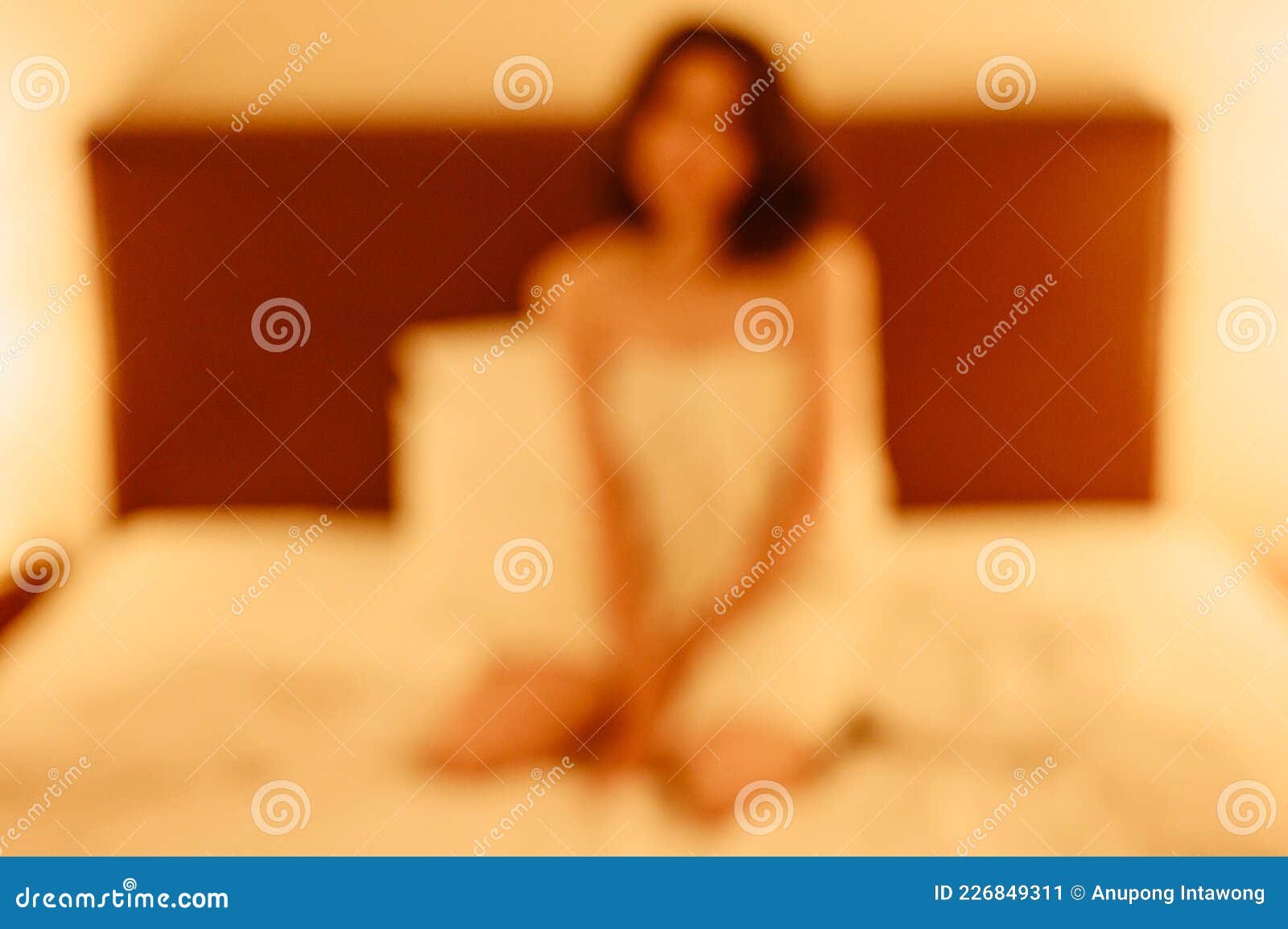 Abstract of Blurred Background Image of Prostitute Woman Waiting for Her Partner, Sitting on the Bed in Hotel