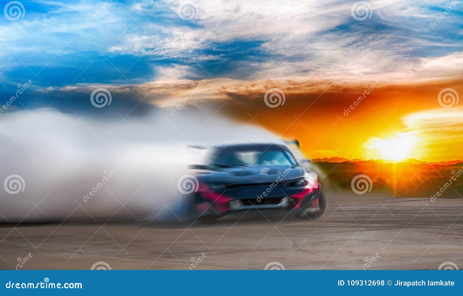 abstract blurred drift car with smoke from burned tire at sunset