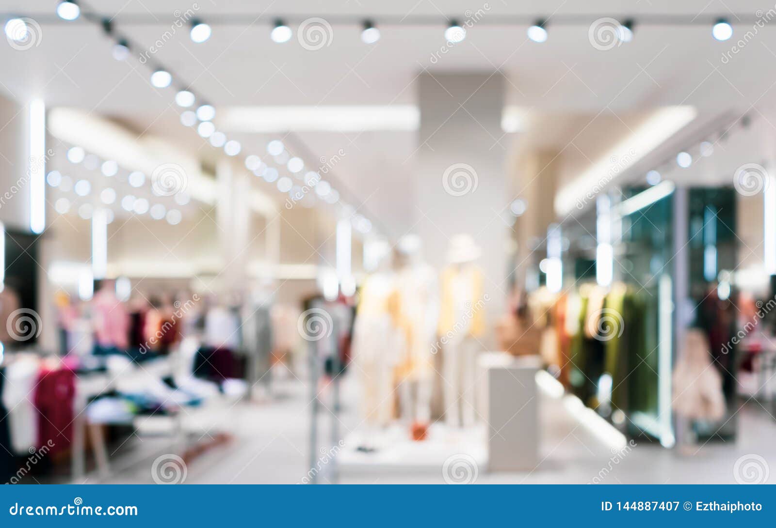 abstract blurred of fashion clothes shop boutique interior in shopping mall, with bokeh light background. blurred image of